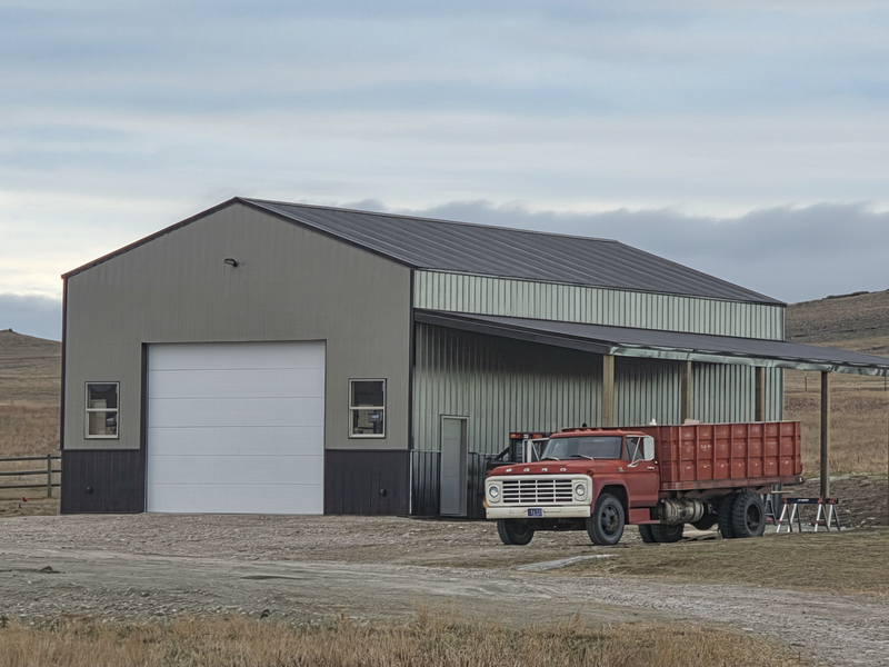 Post frame ag building with red dump truck